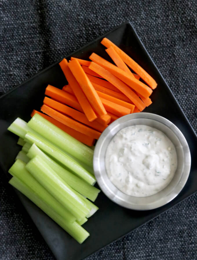 Overhead view of bleu cheese dressing with carrots and celery.